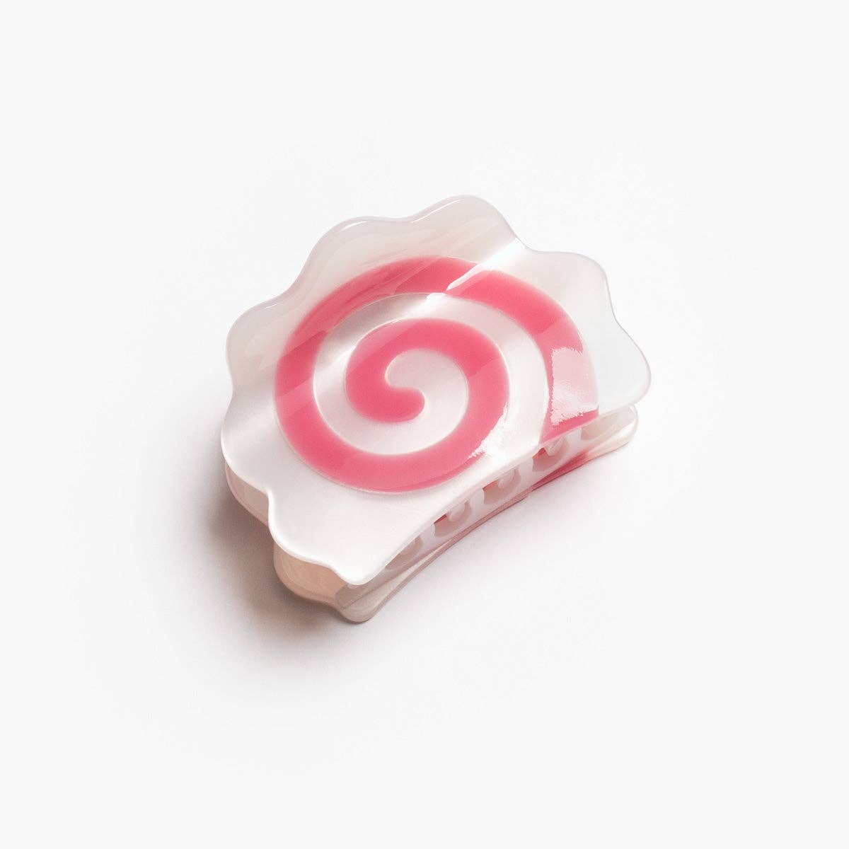 Pink and white spiral candy on a white background