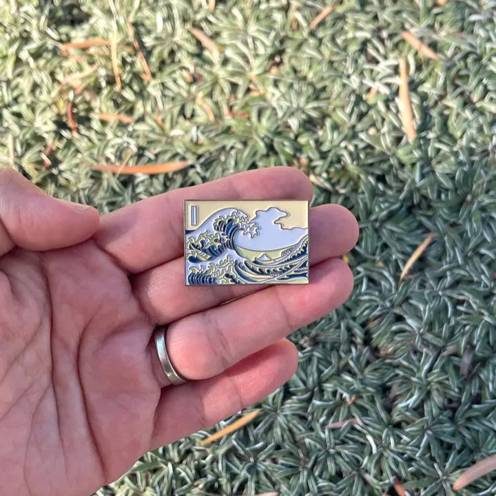 Inspired by "The Great Wave Off Kanagawa" by Hokusai, this pin depicts Hokusai's iconic ukiyo-e painting, The Great Wave Off Kanagawa. Featuring beautiful vibrant colors, this will add a touch of Japanese culture to your wardrobe. An attention-grabbing piece of art, you're sure to get compliments when wearing thi