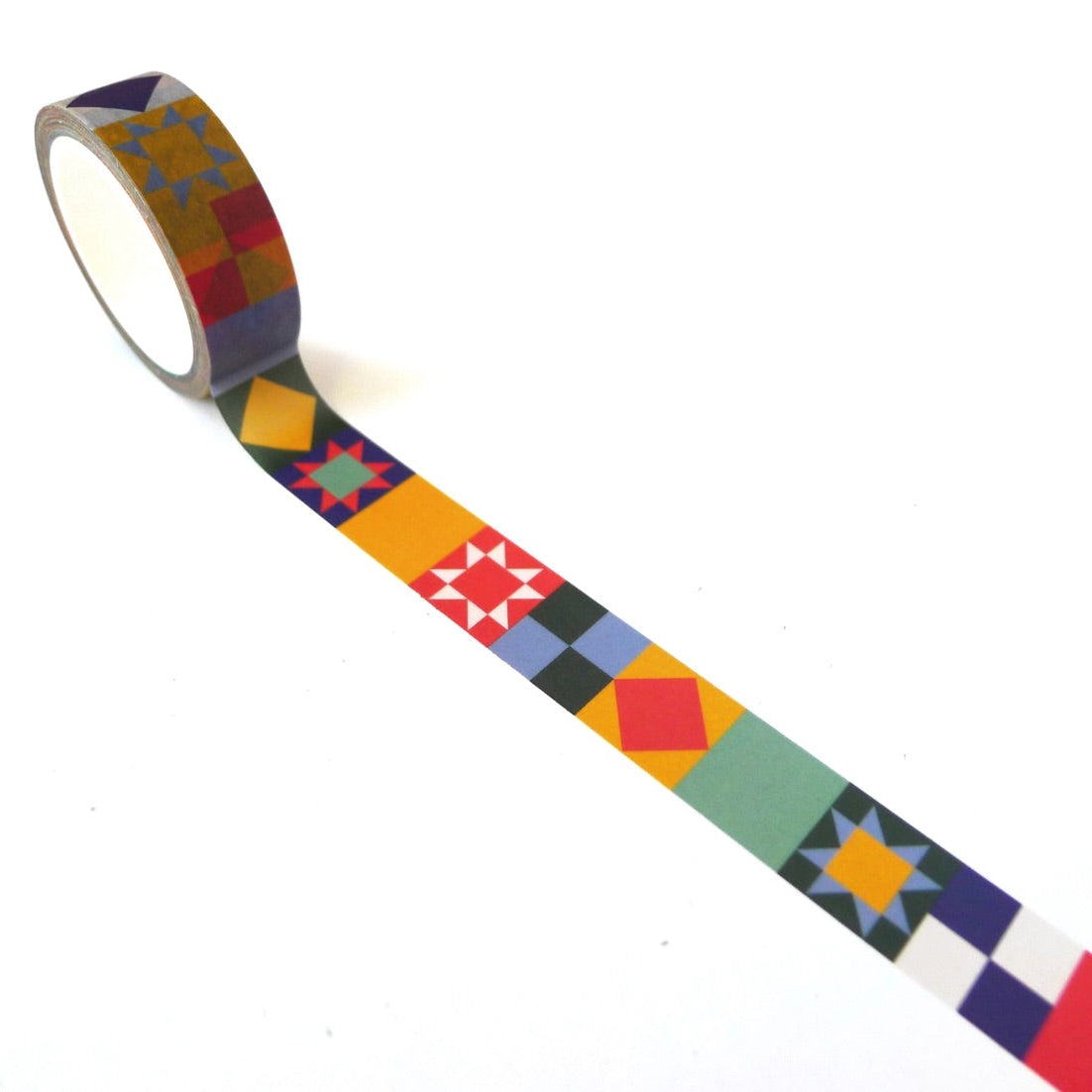 A roll of multicolored quilt washi tape with a geometric pattern, wrapped around a part of the tape to show the design.