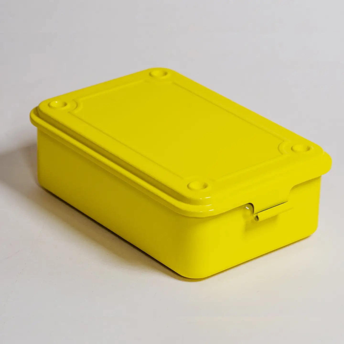 Yellow rectangular storage box with a lid on a light gray background