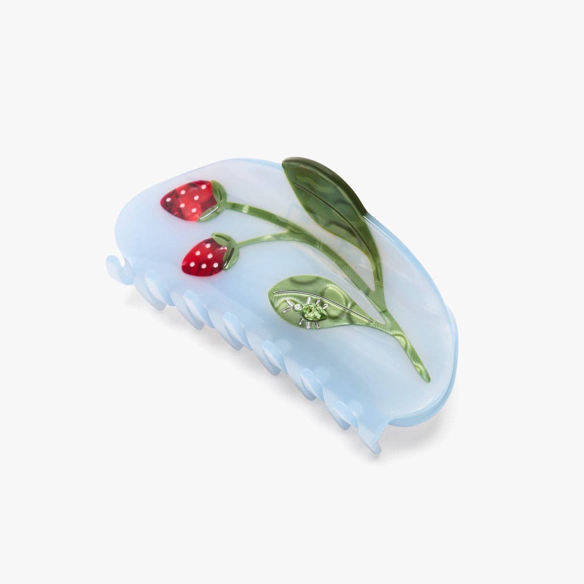 Blue hair comb with strawberry and leaf design on a white background