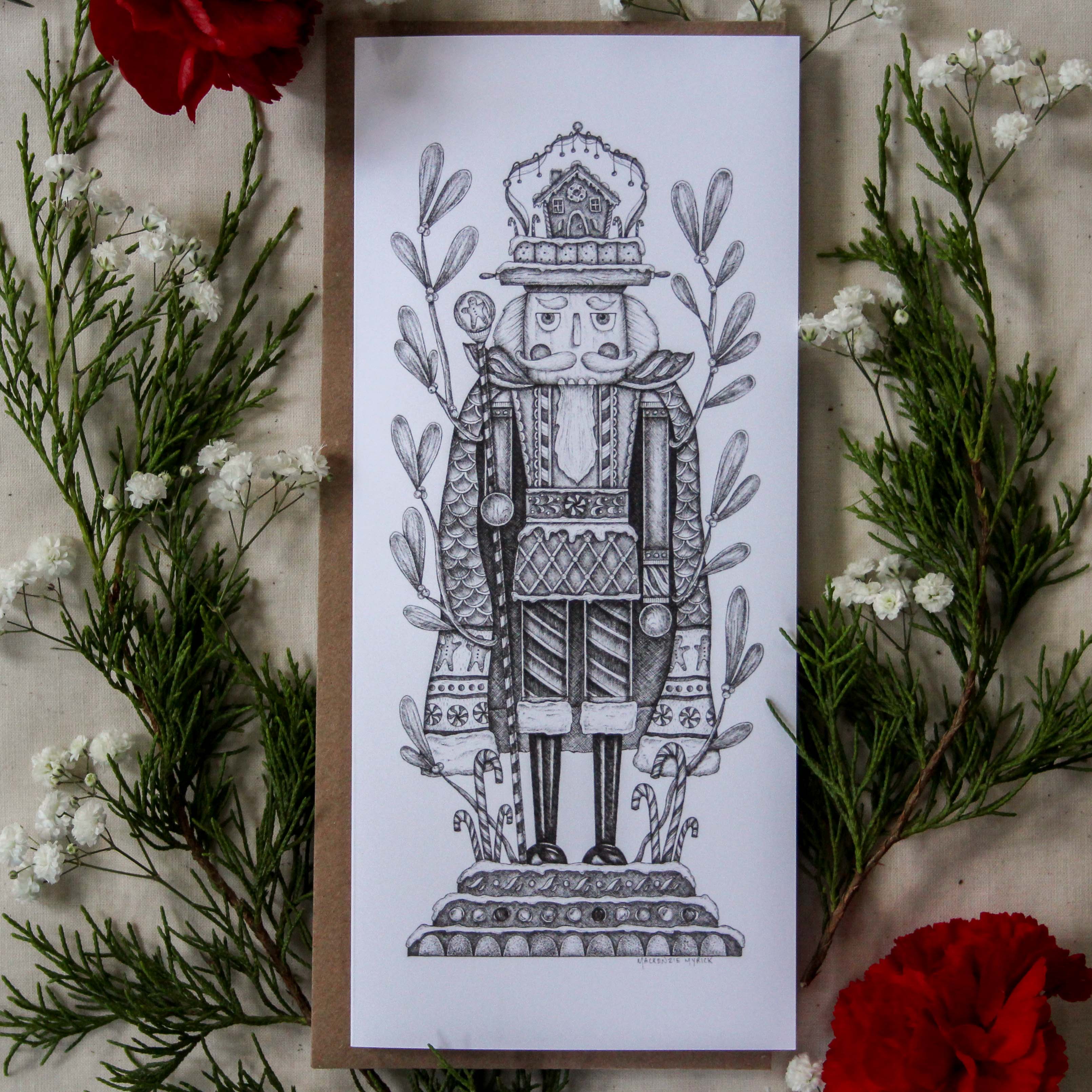 Card with a detailed illustration of a nutcracker surrounded by greenery and red flowers.