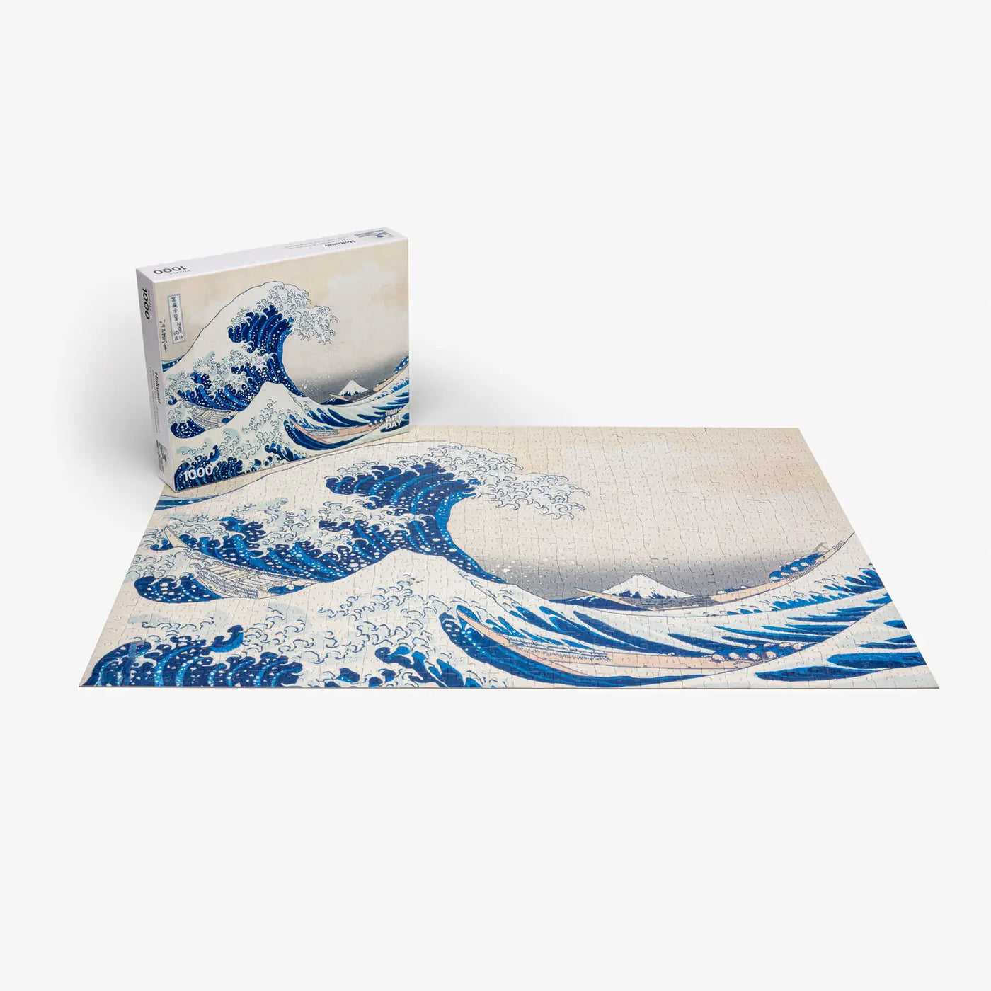 The Great Wave Off Kanagawa is a woodblock print by the Japanese ukiyo-e artist Hokusai. It is part of Hokusai’s thirty-six views of Mount Fuji series that secured his fame both in Japan and overseas. The mountain with a snow-capped peak is Mount Fuji, which in Japan is considered sacred and a symbol of national identity. Sometimes assumed to be a tsunami, the wave is more likely to be a large rogue wave. It is about to strike three boats, symbolizing the force of nature and the weakness of human being