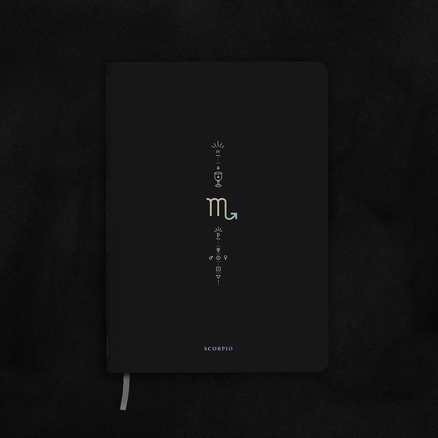 Black notebook with white text on a dark textured background