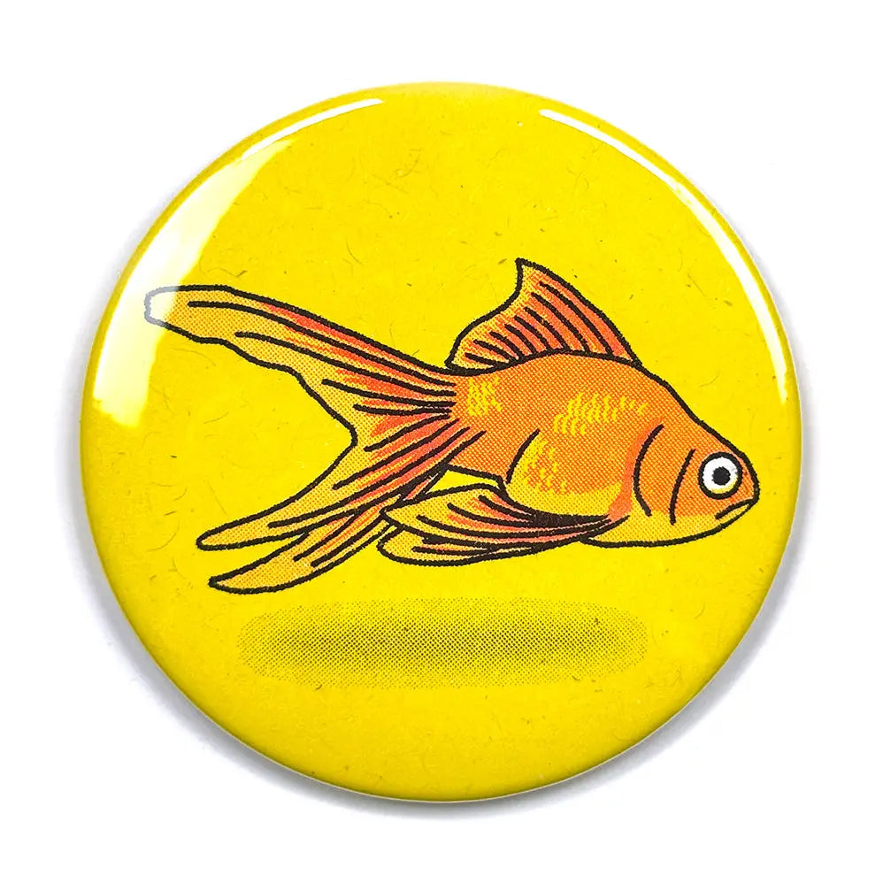 Round button badge with a goldfish illustration on a yellow background