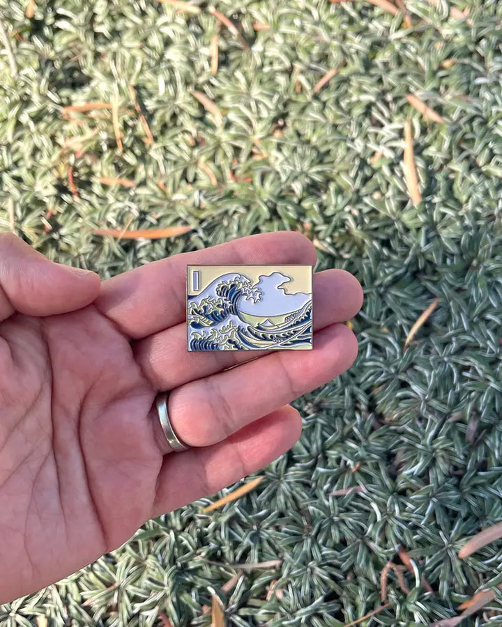 Inspired by "The Great Wave Off Kanagawa" by Hokusai, this pin depicts Hokusai's iconic ukiyo-e painting, The Great Wave Off Kanagawa. Featuring beautiful vibrant colors, this will add a touch of Japanese culture to your wardrobe. An attention-grabbing piece of art, you're sure to get compliments when wearing thi