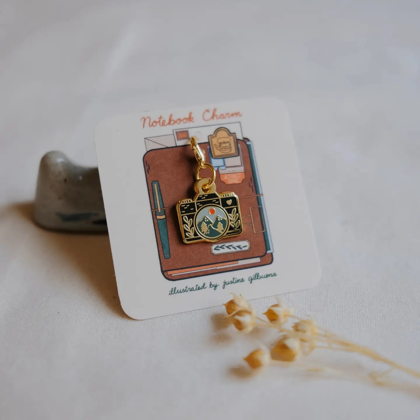 Notebook charm on a card with a white background