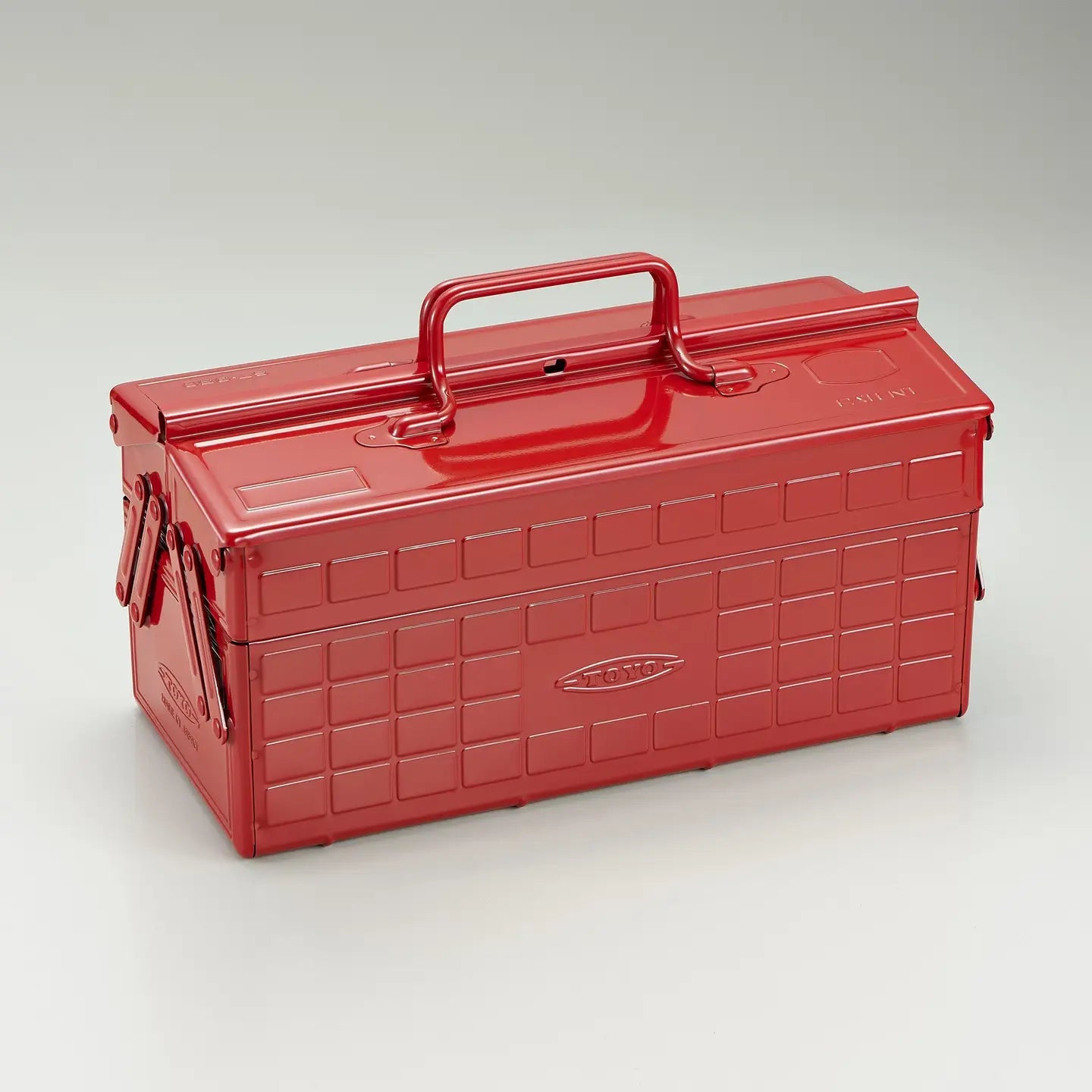Red toolbox with a handle on a light gray background