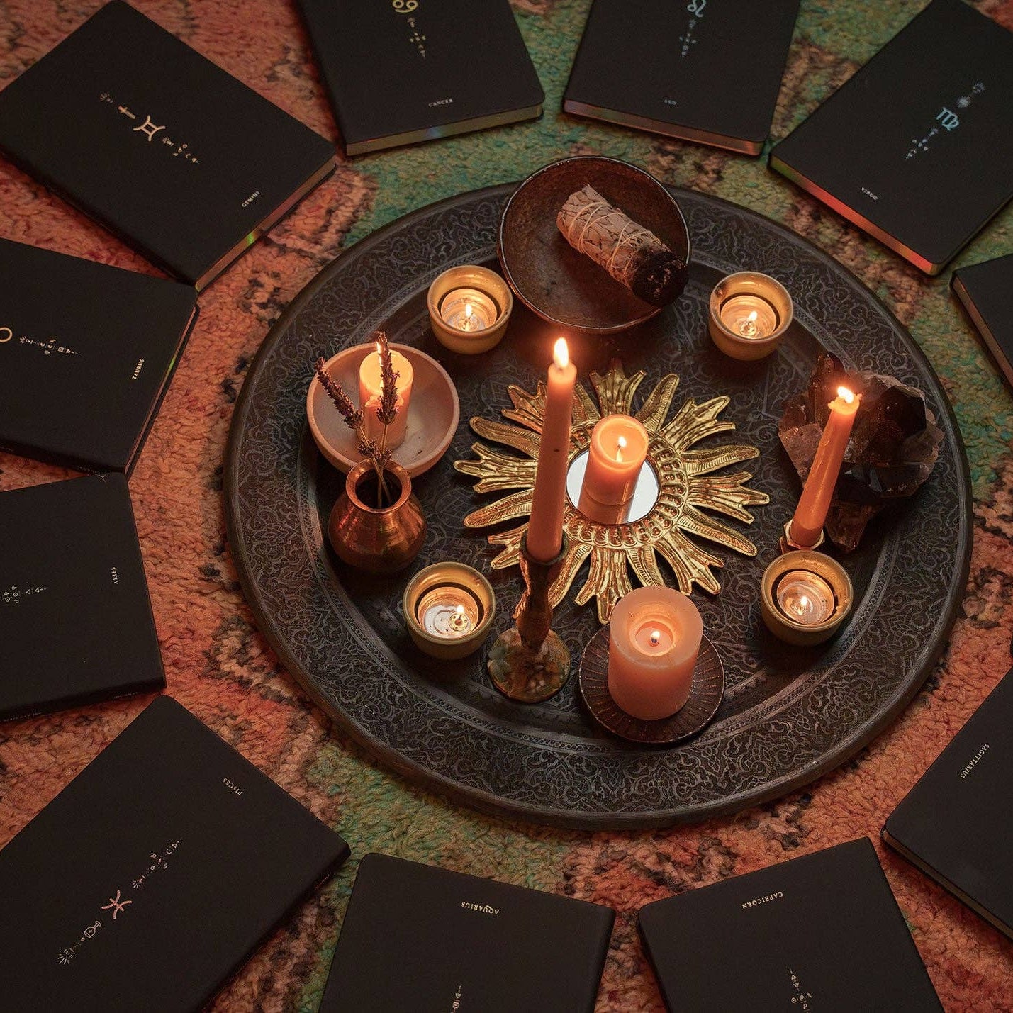 Candlelit scene with astrological cards arranged in a circle on a textured surface.