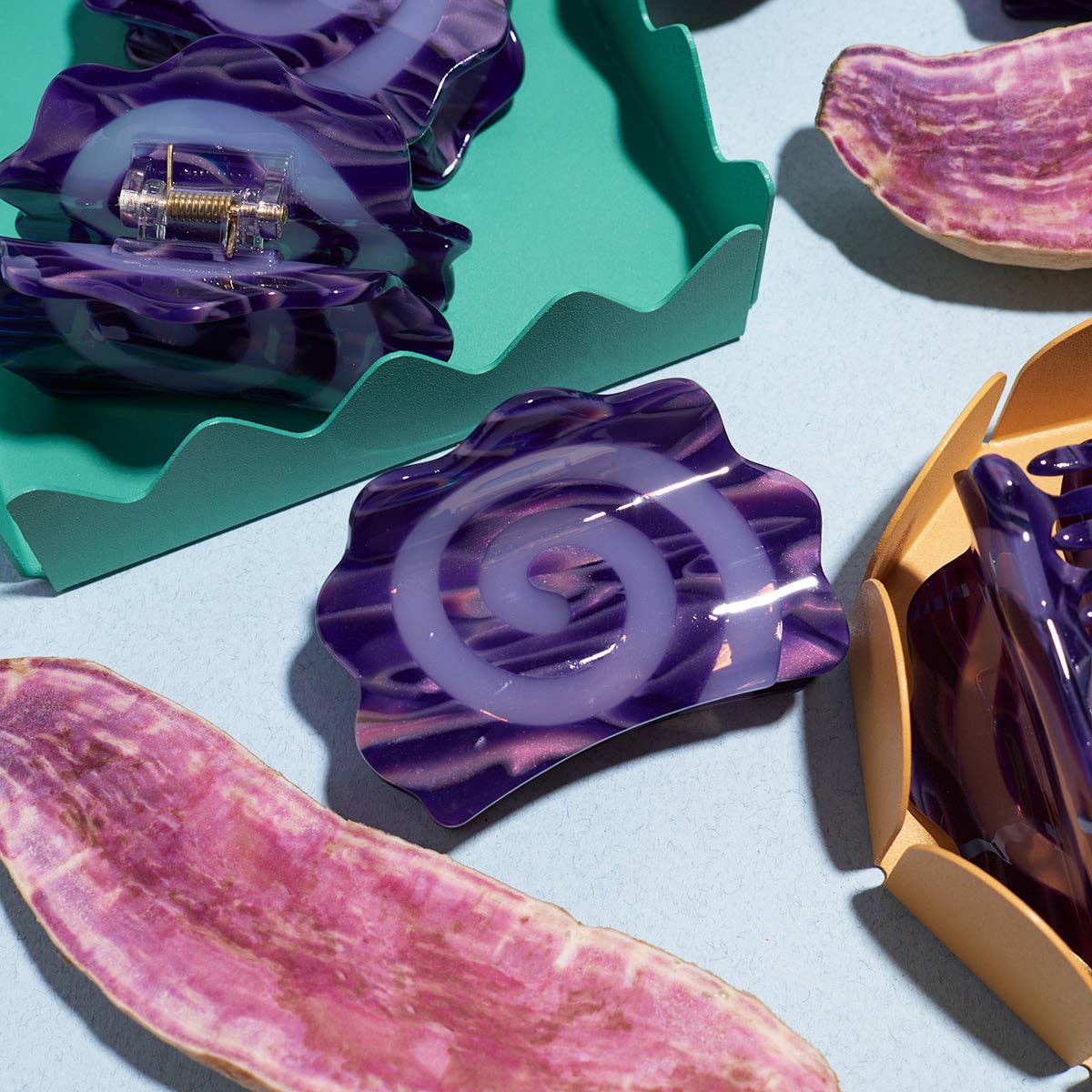 Colorful resin hair clips on a light blue background