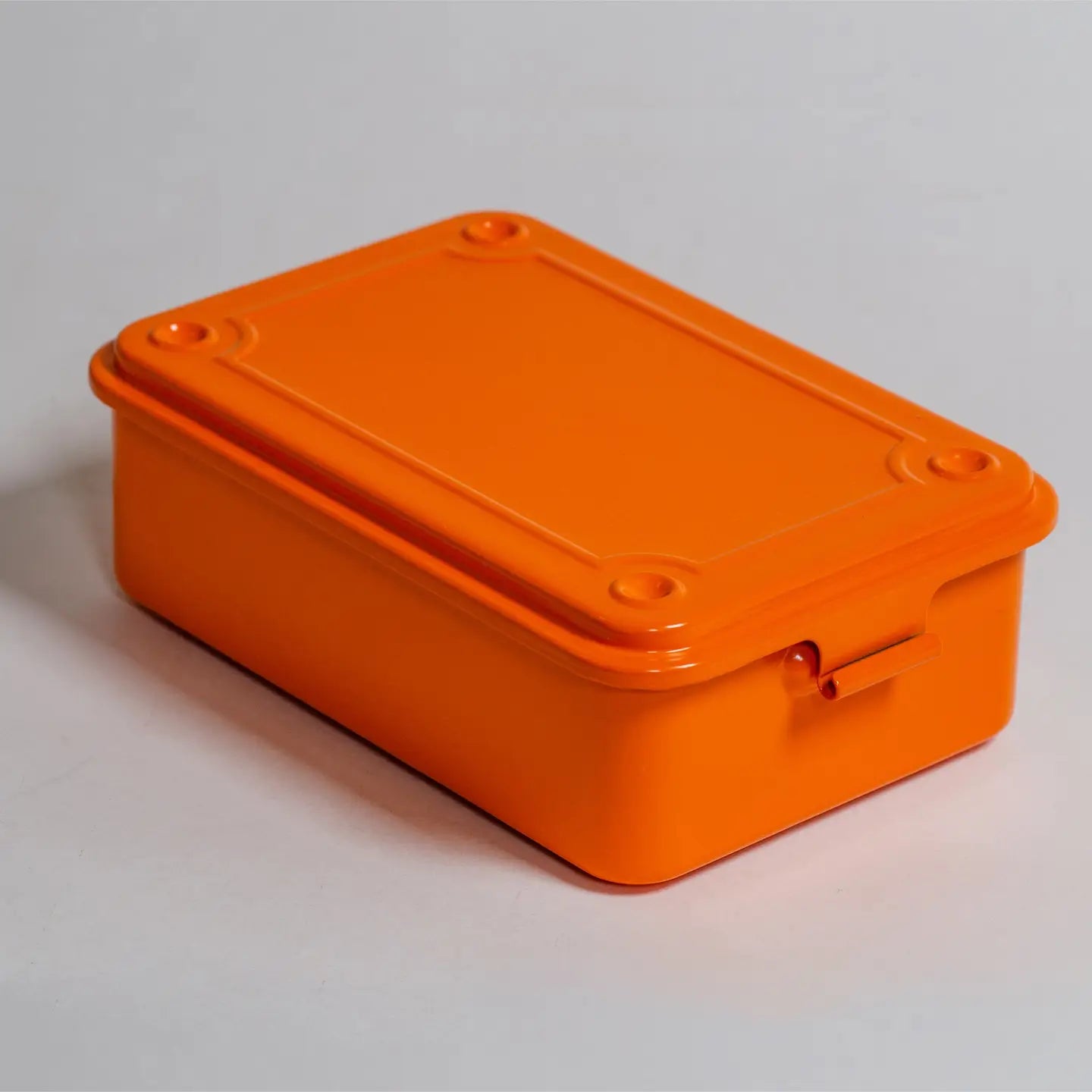 Orange rectangular box with a lid on a light gray background