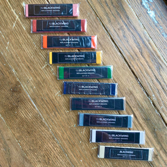 Blackwing Pencils have always been known for their iconic, replaceable, square erasers. To replace your eraser, slide the eraser and clip out of the ferrule, remove the clip from the old eraser, place the new eraser into the clip, and insert the new eraser and clip into the ferrule.  Replacement erasers come in sets of 10 and are available in black, white, pink, green, blue, navy blue, orange, yellow, red and grey.  Details: Set of 10 Pencil Eraser Replacements Single-Color Packs