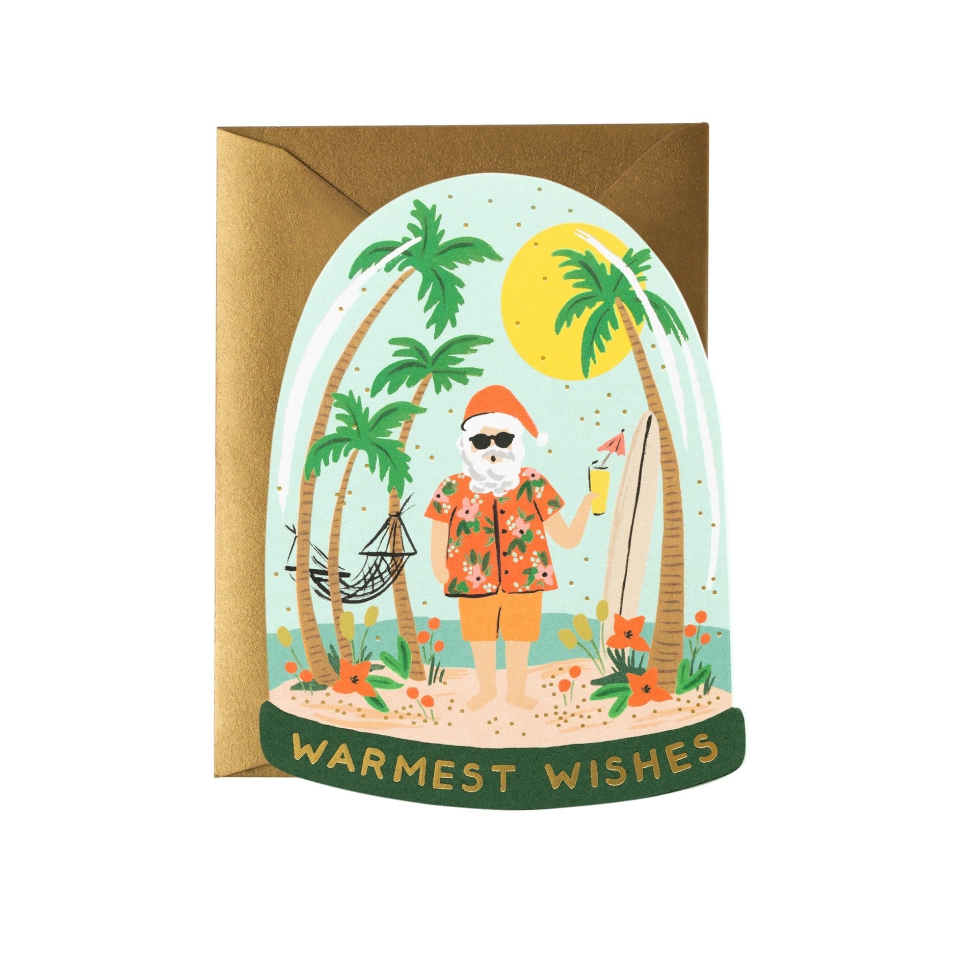 A die-cut holiday card featuring a snow globe with Santa Claus on an island with palm trees, a hammock, and a beach setting. The text on the card reads 'WARMEST WISHES'.