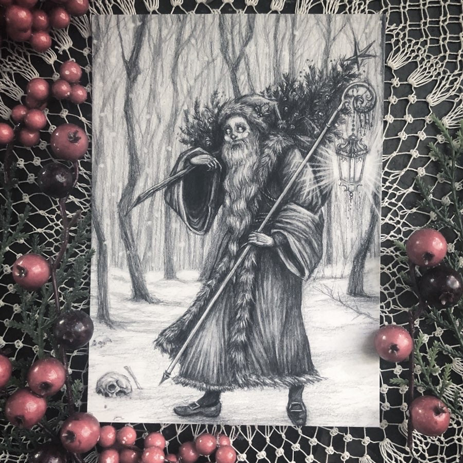 Greeting card featuring a black and white illustration of a character resembling a skeleton or a wizard, surrounded by holly and pine cones, with a black envelope included.
