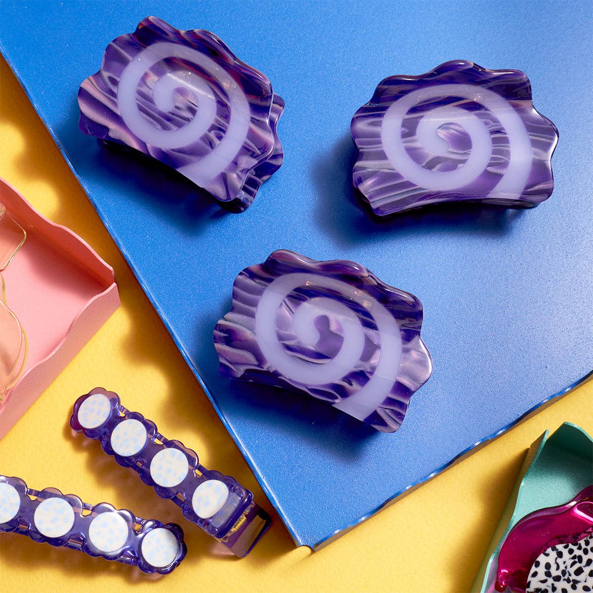 Purple and white spiral-shaped objects on a blue and yellow background