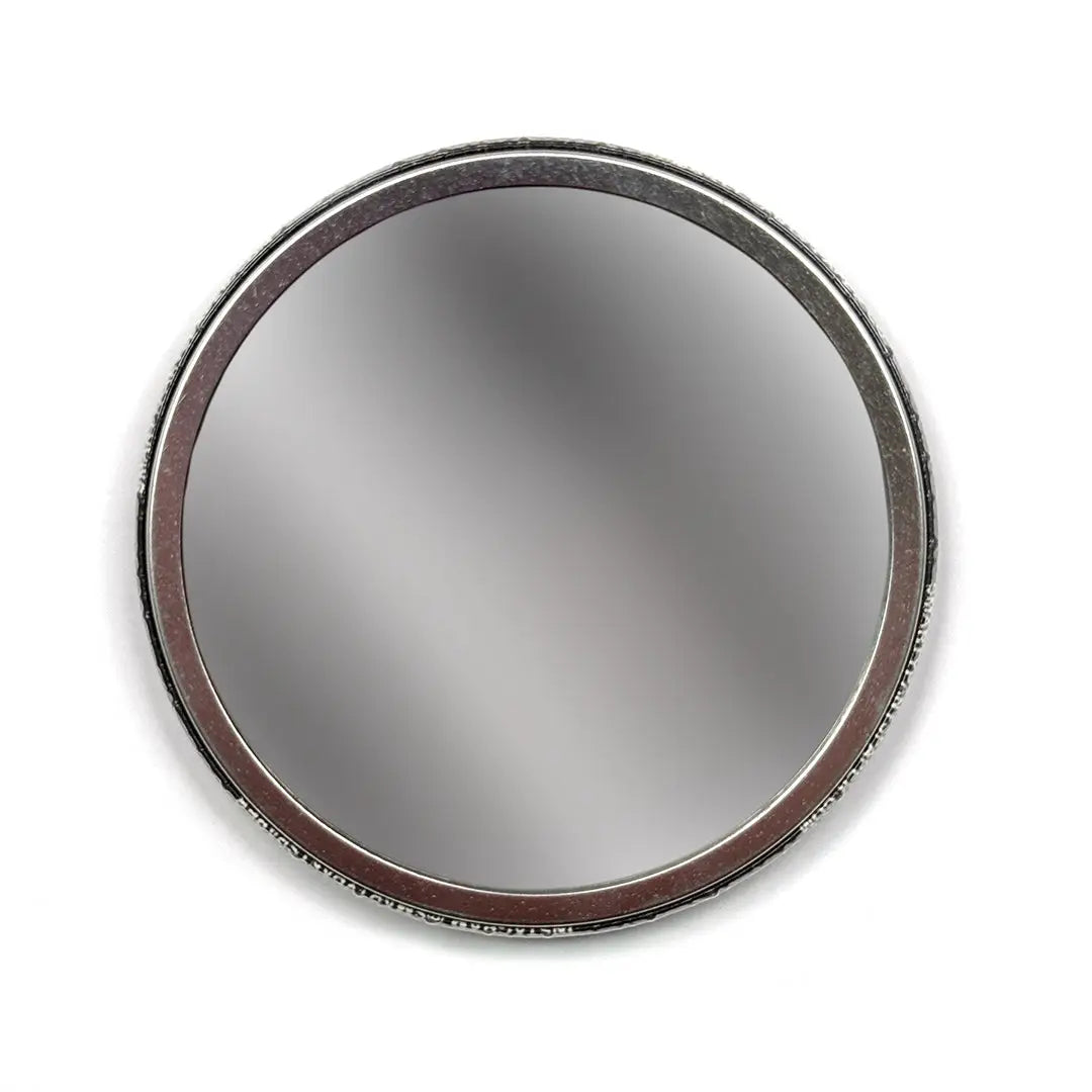 Round mirror with a metallic frame on a white background
