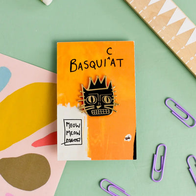 The ‘cat artist' enamel pin range is a feline reimagining of some of the greatest artists of all time.  The 'Basquicat' is a feline interpretation of street art legend, Jean-Michel Basquiat now reimagined as 'Basquicat.’  Details: 1" x 1" Metal Locking Clasps  By Niaski