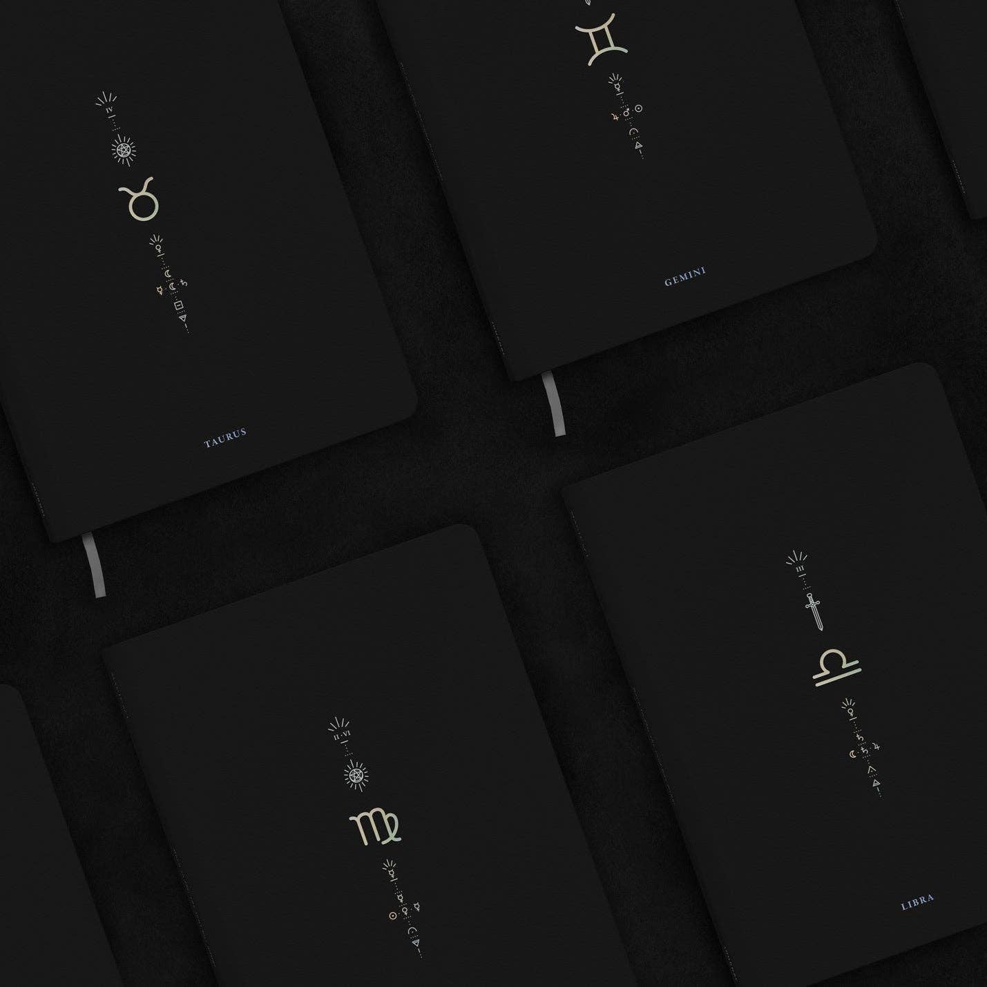 Dark background with zodiac symbol designs