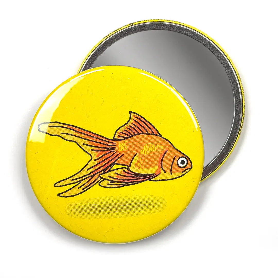 Round yellow magnet with a goldfish illustration on a white background