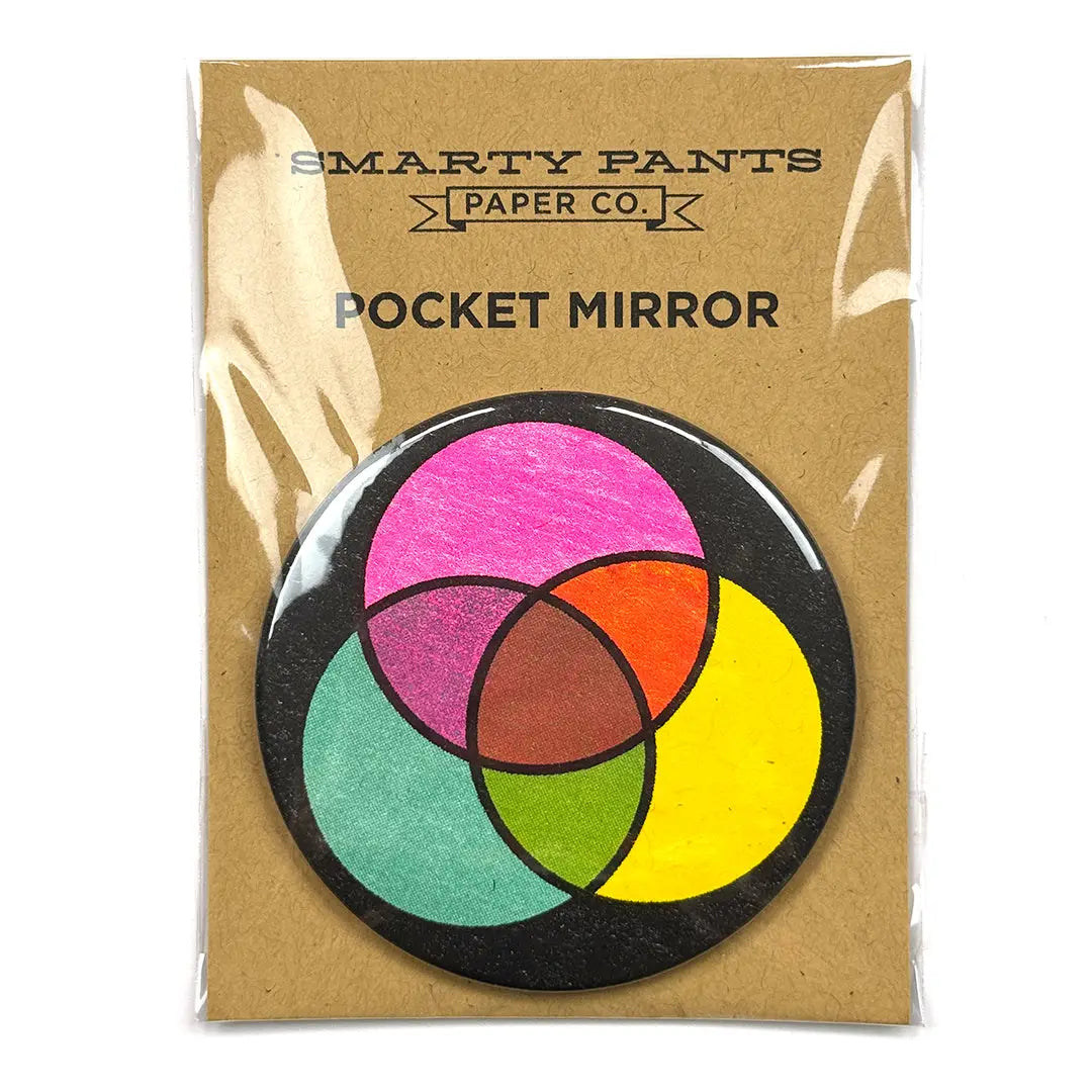 Pocket mirror with color wheel design on a brown paper packaging with 'Smarty Pants Paper Co.' branding.