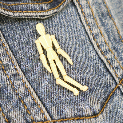 He’s pretty comfortable staying in the way you situate him so that you can move this little mannequin’s arms up to his elbows and his legs up to his knees!  P.S. The perfect companion for any artist’s bag!  Details: 2" x .6” Interactive Enamel Pin 4 Points of Articulation Metal Locking Clasp  By Pin Museum